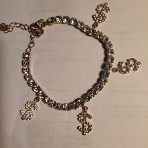CHARM BRACLET. GOLD AND SWAROWSKI CRYSTALS